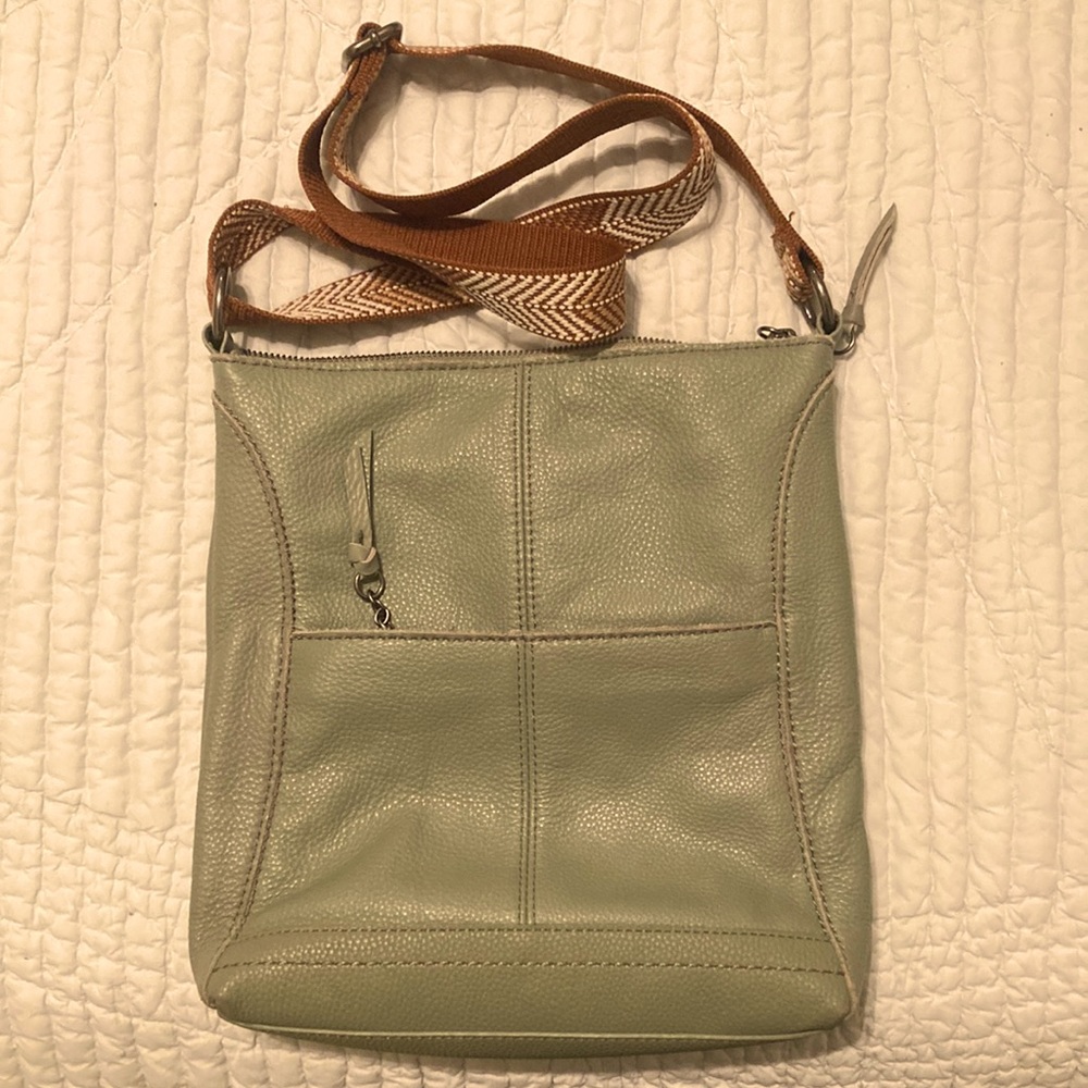 Like new the sak handbag. Sage green with adjustable arrow print strap.